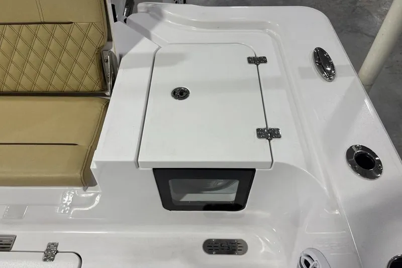 Slide: The Image of 2025 Sportsman Masters 267OE Bay Boat interior with tan seating and storage compartment. - 23