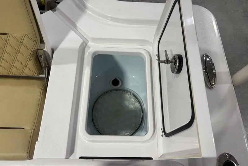 Slide: The Image of Open storage compartment on 2025 Sportsman Masters 267OE Bay Boat, featuring beige seating. - 26