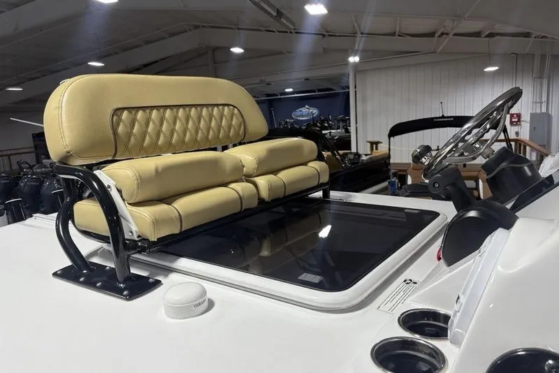 Slide: The Image of 2025 Sportsman Masters 267OE Bay Boat helm with cushioned seating and steering wheel. - 27