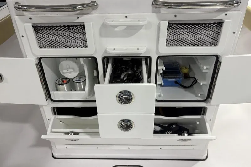 Slide: The Image of 2025 Sportsman Masters 267OE Bay Boat storage compartments with organized fishing gear and accessories. - 28