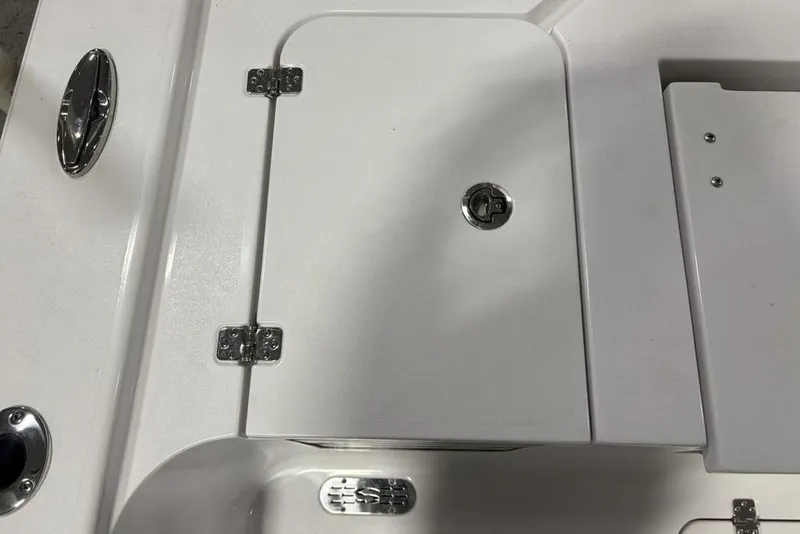 Slide: The Image of 2025 Sportsman Masters 267OE Bay Boat deck with storage compartment and chrome fittings. - 31