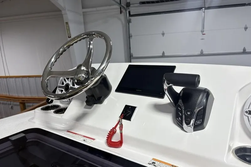 Slide: The Image of 2025 Sportsman Masters 267OE Bay Boat helm with steering wheel and controls. - 34