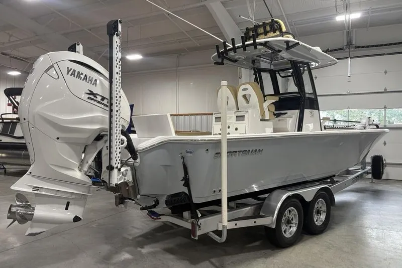 Slide: The Image of 2025 Sportsman Masters 267OE Bay Boat with Yamaha engine in indoor showroom. - 4