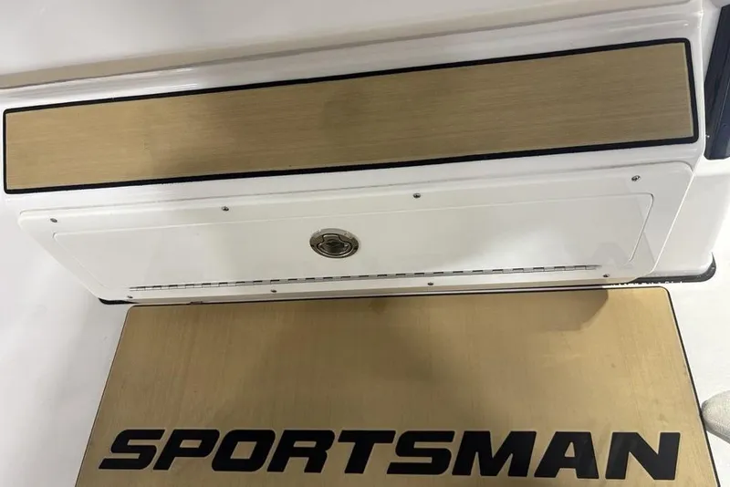 Slide: The Image of 2025 Sportsman Masters 267OE Bay Boat deck with logo and storage compartment. - 8