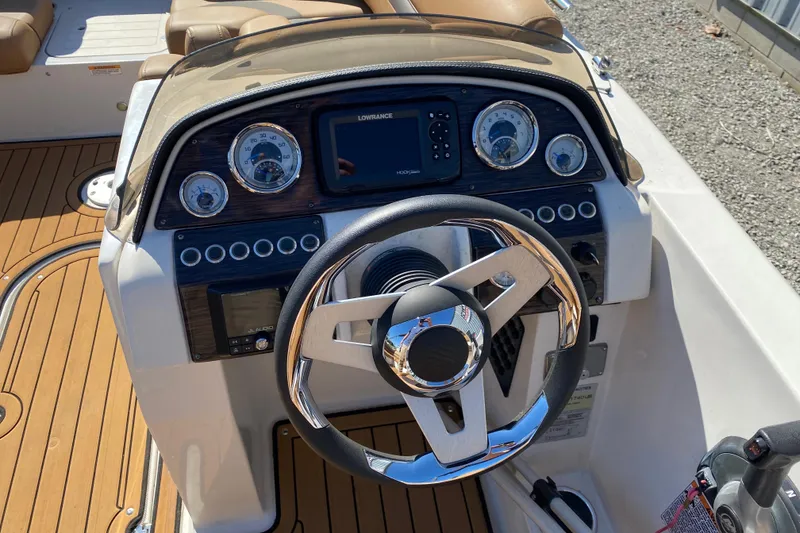 Slide: The Image of Steering console of 2022 Starcraft Star Step 221 E I/O boat with gauges and controls. - 11