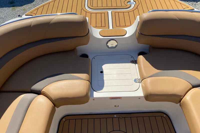 Slide: The Image of 2022 Starcraft Star Step 221 E I/O boat interior with tan seating and wood finish. - 15