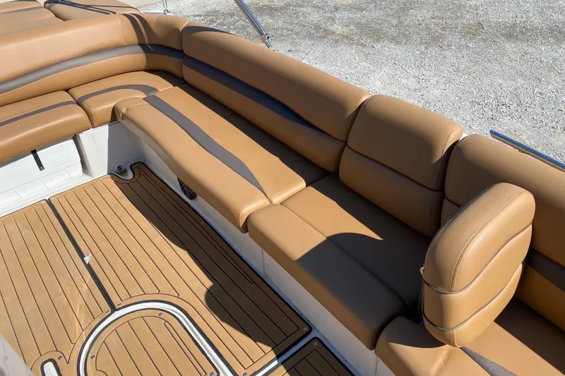 Slide: The Image of 2022 Starcraft Star Step 221 E I/O boat interior with tan seating and wood-style flooring. - 17