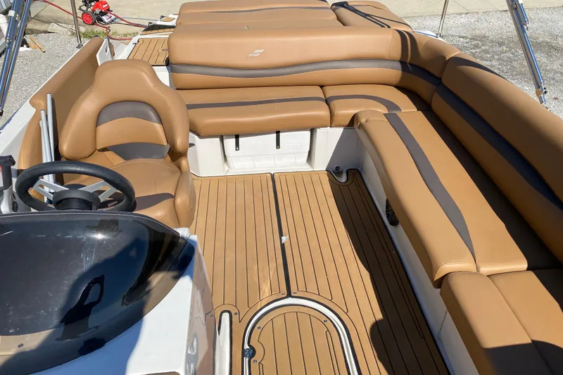 Slide: The Image of 2022 Starcraft Star Step 221 E I/O boat interior with tan seating and steering wheel. - 18