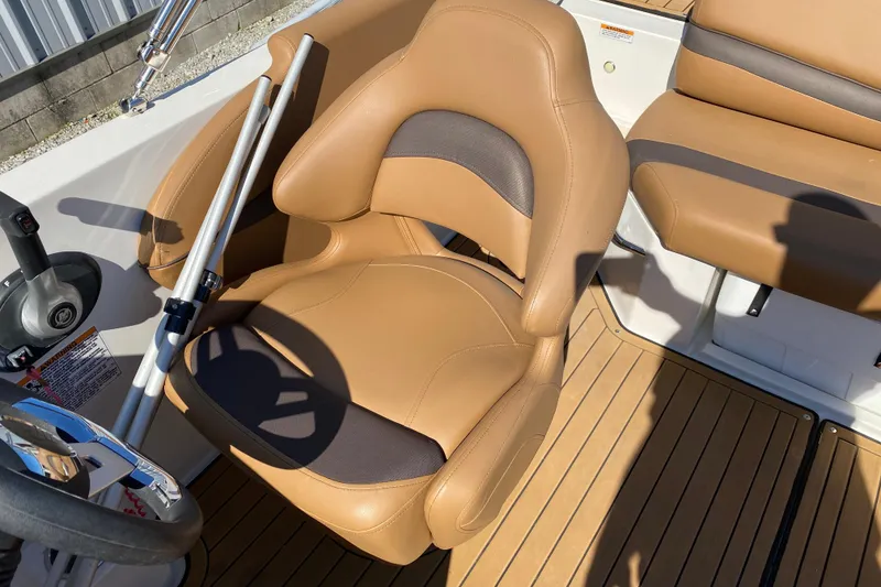 Slide: The Image of 2022 Starcraft Star Step 221 E I/O boat interior with tan seating and steering wheel. - 19