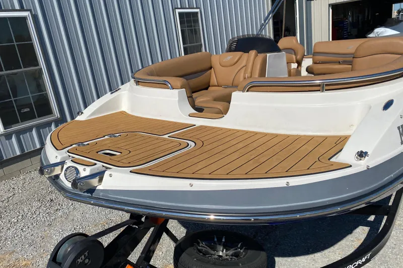 Slide: The Image of 2022 Starcraft Star Step 221 E I/O boat with tan seating and wood deck. - 5