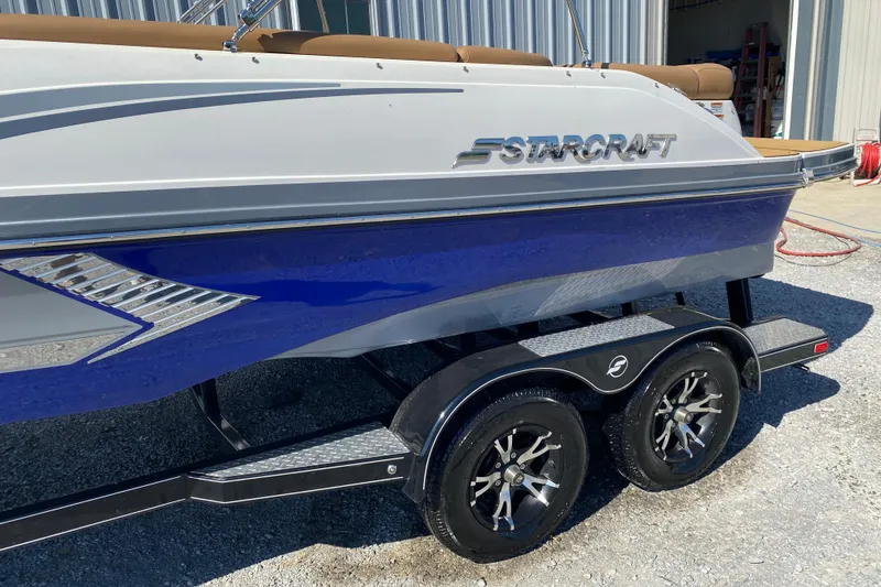 Slide: The Image of 2022 Starcraft Star Step 221 E I/O boat on trailer, blue and white design. - 6