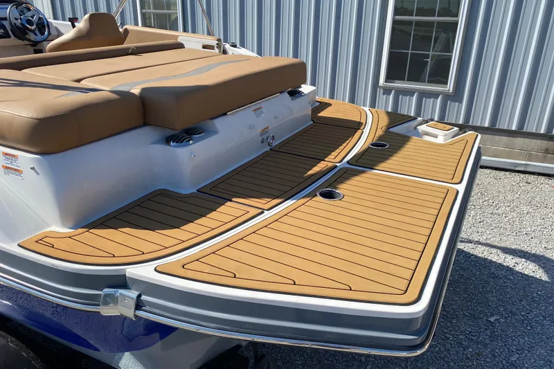 Slide: The Image of 2022 Starcraft Star Step 221 E I/O boat with tan seating and wooden deck. - 7