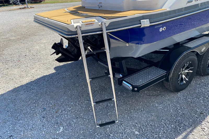 Slide: The Image of 2022 Starcraft Star Step 221 E I/O boat with ladder and trailer on gravel. - 9