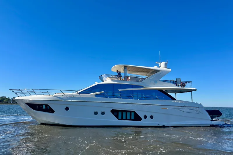 Slide: The Image of Luxurious 2016 Absolute 72 FLY yacht cruising on open water under clear blue sky. - 106