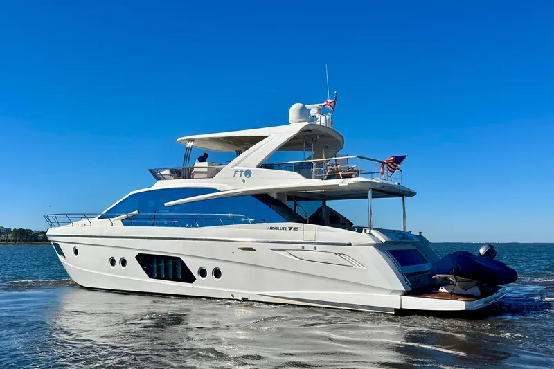 Slide: The Image of Luxurious 2016 Absolute 72 FLY yacht cruising on open water under clear blue skies. - 109