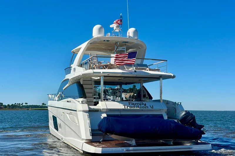 Slide: The Image of Luxury yacht Absolute 72 FLY 2016 on water, American flag displayed, clear blue sky. - 114