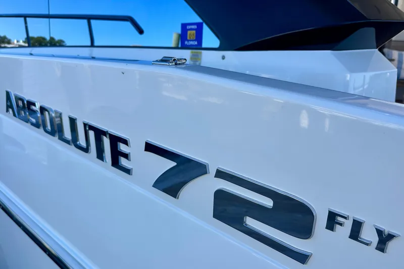 Slide: The Image of Close-up of Absolute 72 FLY yacht nameplate, 2016 model, in a marina setting. - 120
