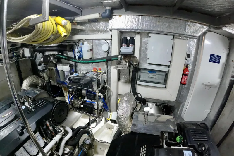 Slide: The Image of Engine room of 2016 Absolute 72 FLY yacht with equipment and fire extinguisher. - 128