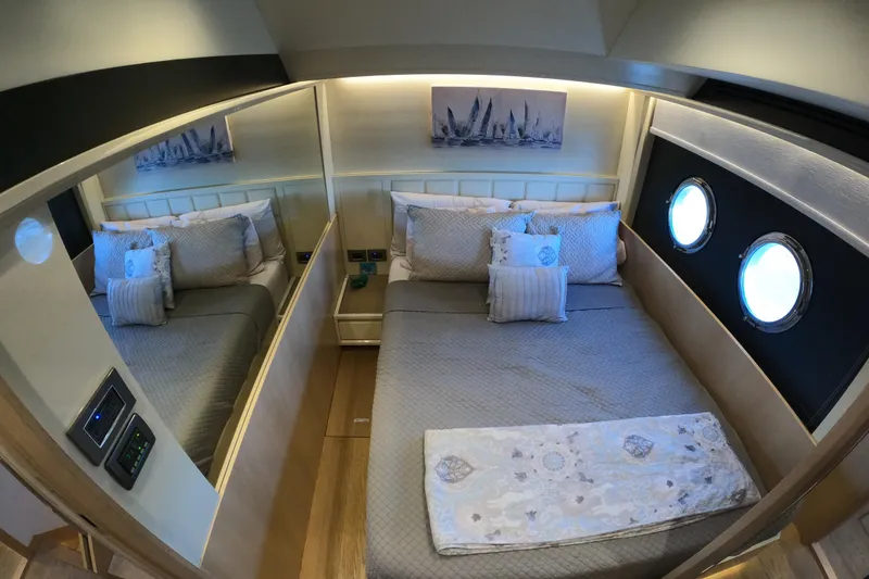Slide: The Image of Luxurious bedroom interior on 2016 Absolute 72 FLY yacht with elegant bedding and porthole windows. - 146