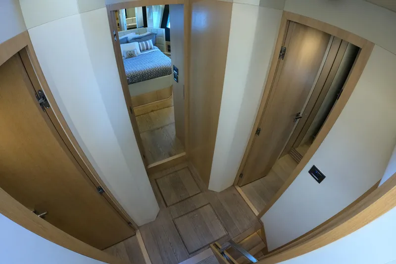 Slide: The Image of Interior hallway of 2016 Absolute 72 FLY yacht with wooden doors and bedroom view. - 156