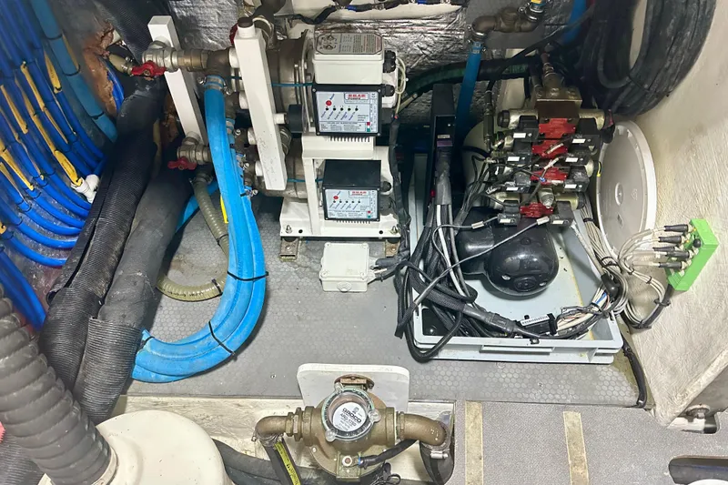 Slide: The Image of Engine room of a 2016 Absolute 72 FLY yacht with complex wiring and machinery. - 23
