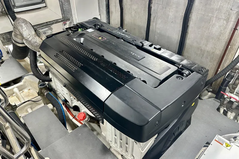 Slide: The Image of Engine room of a 2016 Absolute 72 FLY yacht, showcasing a powerful marine engine. - 27