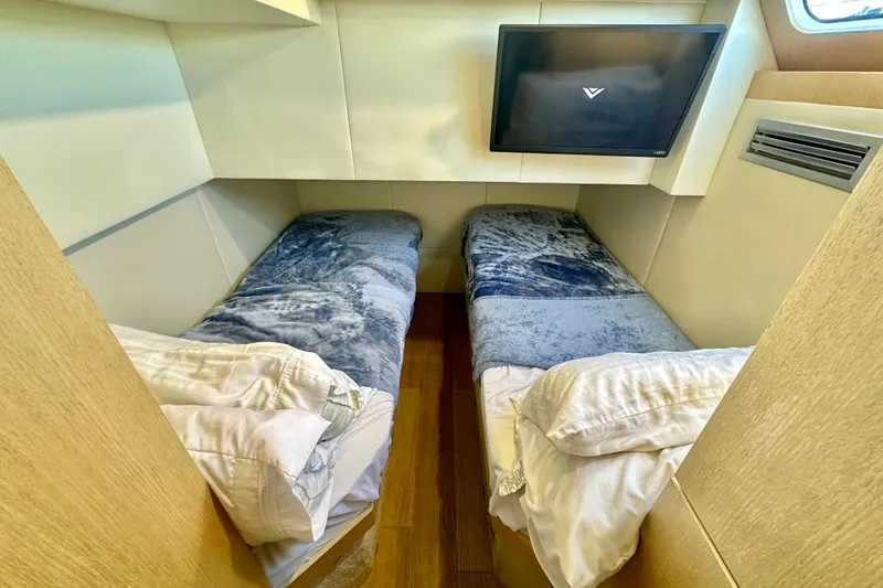 Slide: The Image of Twin beds in a cozy cabin of a 2016 Absolute 72 FLY yacht. - 38