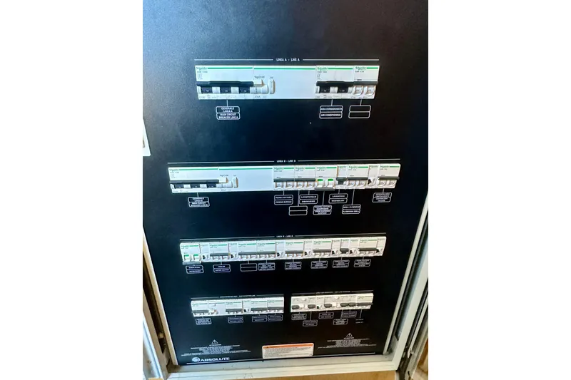 Slide: The Image of Electrical panel on Absolute 72 FLY yacht, 2016 model, featuring multiple circuit breakers. - 43