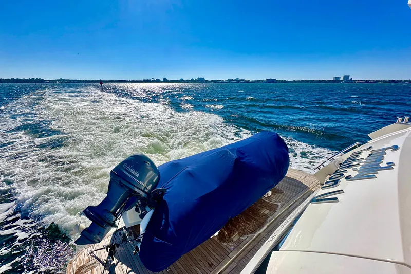 Slide: The Image of Luxury yacht Absolute 72 FLY cruising on open water, Yamaha engine visible. - 44