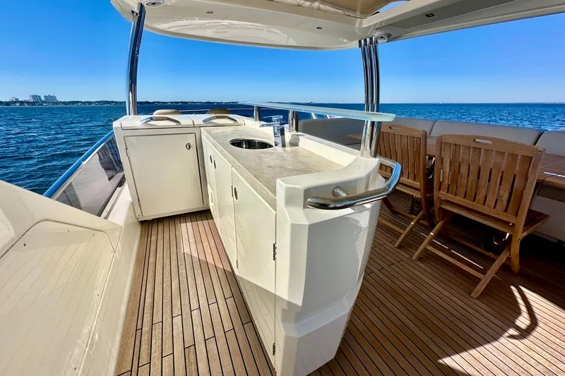 Slide: The Image of Luxurious 2016 Absolute 72 FLY yacht deck with outdoor kitchen and seating, overlooking the ocean. - 57