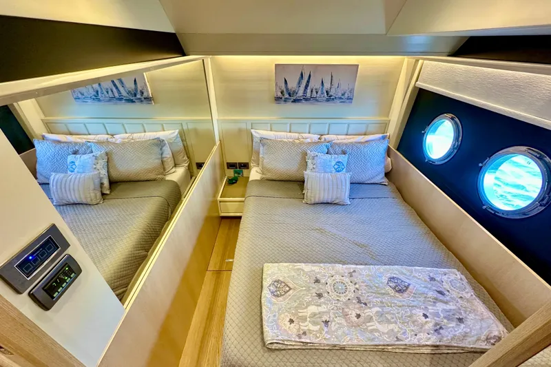 Slide: The Image of Luxurious bedroom interior of 2016 Absolute 72 FLY yacht with elegant bedding and porthole windows. - 65