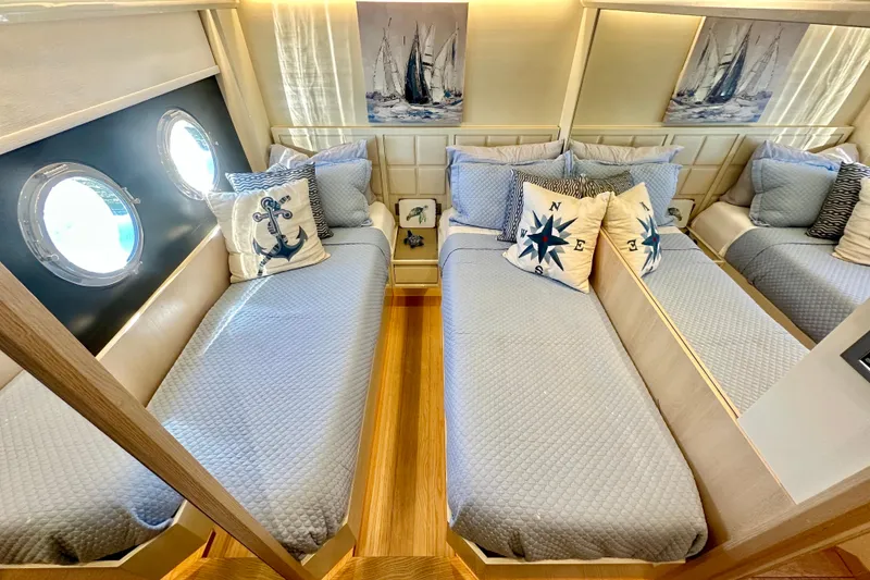 Slide: The Image of Luxurious twin cabin on 2016 Absolute 72 FLY yacht with nautical decor and porthole windows. - 66