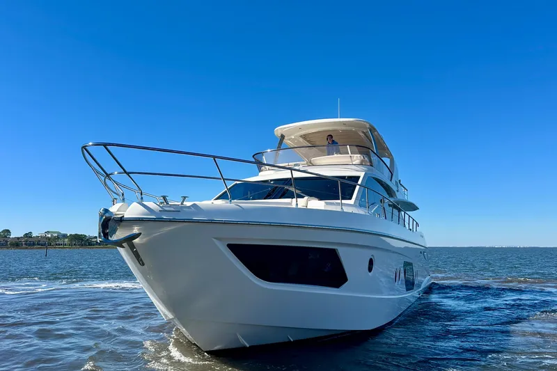 Slide: The Image of Luxurious 2016 Absolute 72 FLY yacht cruising on open water under clear blue skies. - 76