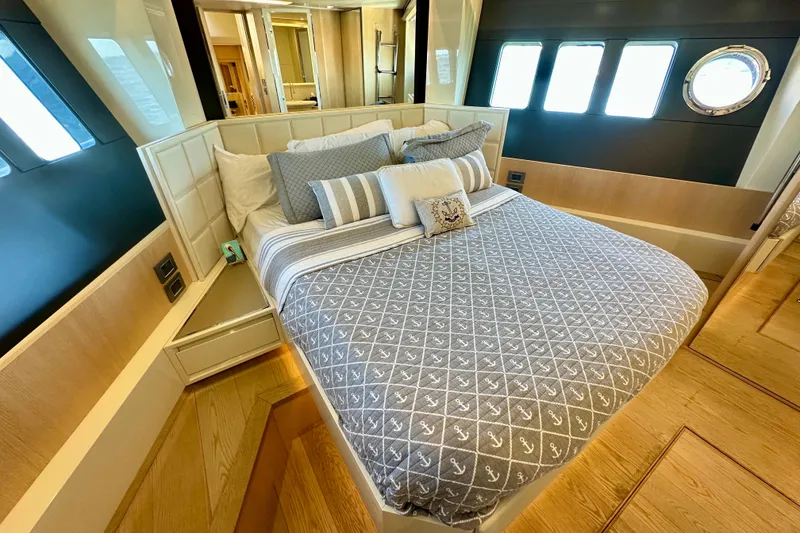 Slide: The Image of Luxurious bedroom interior on 2016 Absolute 72 FLY yacht with elegant bedding and wood accents. - 92