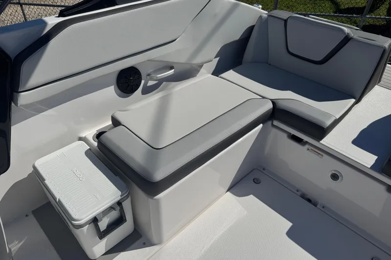 Slide: The Image of 2025 Yamaha Boats SX250 interior seating with storage and cooler. - 13