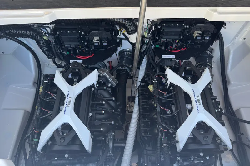 Slide: The Image of Engine compartment of 2025 Yamaha Boats SX250, featuring dual high-output engines. - 19