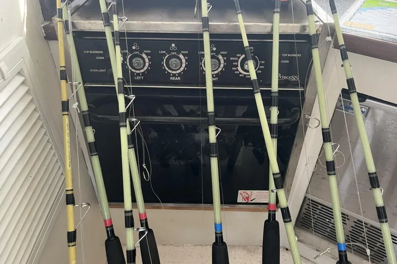 Slide: The Image of Fishing rods leaning against a stove on a 1983 Custom Key West 39' Sportfish boat. - 12
