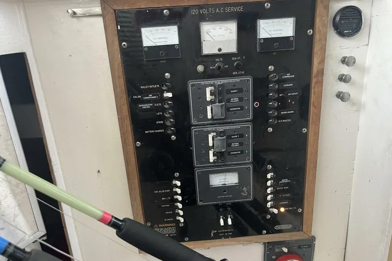 Slide: The Image of Electrical panel on 1983 Custom Key West 39' Sportfish boat, featuring various switches and meters. - 14