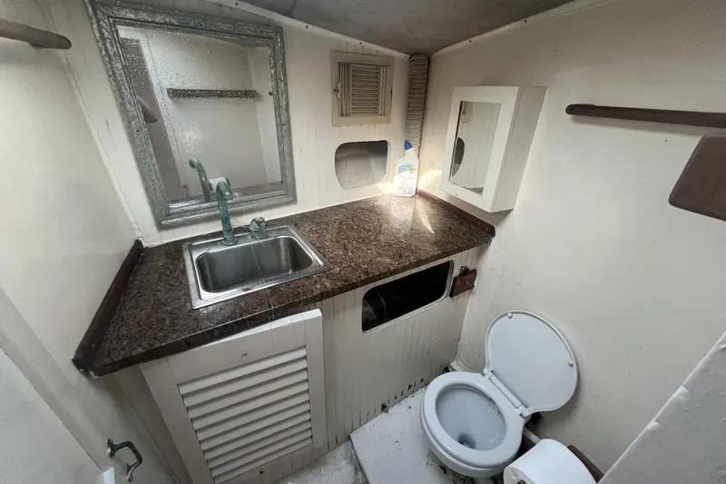 Slide: The Image of Bathroom interior of 1983 Custom Key West 39' Sportfish with sink and toilet. - 18