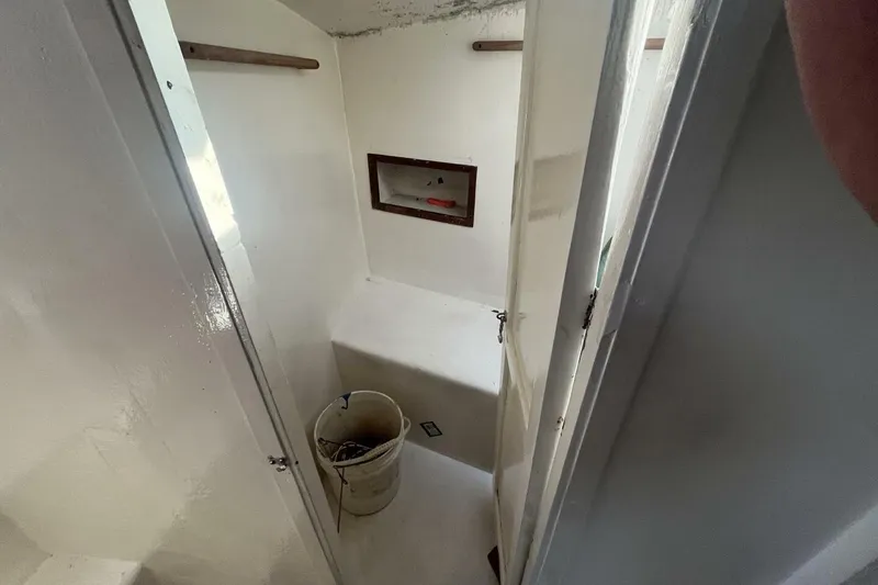 Slide: The Image of Interior of 1983 Custom Key West 39' Sportfish boat, featuring a small storage area. - 19