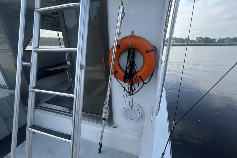 Slide: The Image of 1983 Custom Key West 39' Sportfish boat with ladder and life preserver. - 21