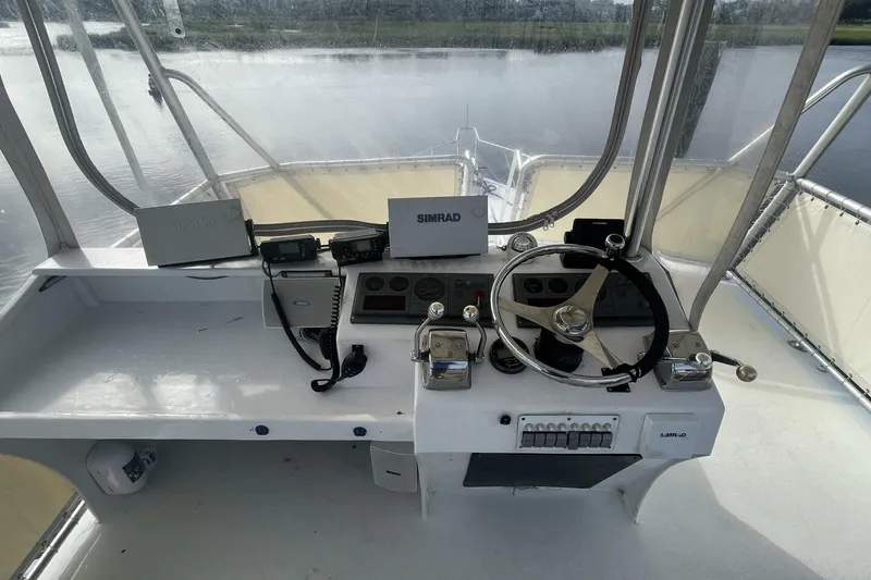 Slide: The Image of Cockpit of 1983 Custom Key West 39' Sportfish with steering wheel and navigation equipment. - 27