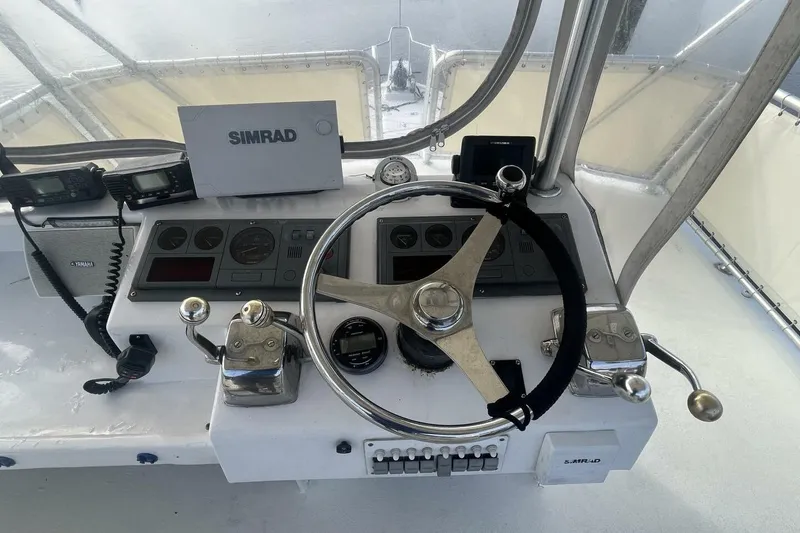 Slide: The Image of Helm of 1983 Custom Key West 39' Sportfish with steering wheel and navigation equipment. - 28