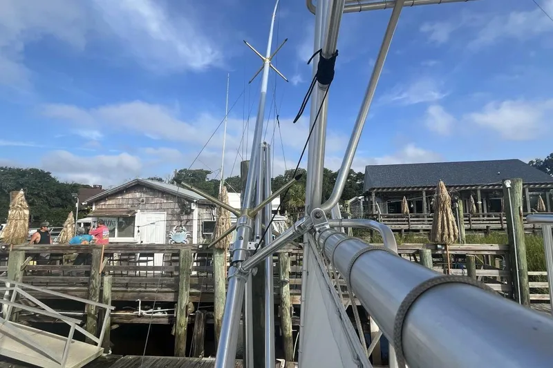 Slide: The Image of Docked 1983 Custom Key West 39' Sportfish with marina backdrop and clear sky. - 29