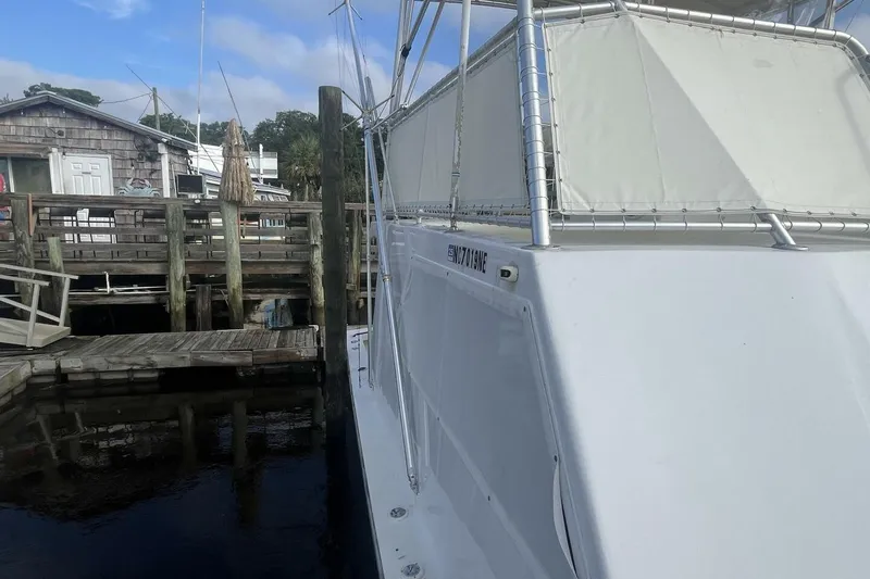 Slide: The Image of 1983 Custom Key West 39' Sportfish docked near wooden pier, clear sky. - 33