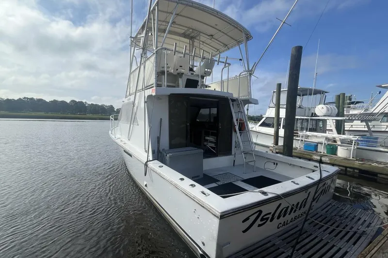 Slide: The Image of 1983 Custom Key West 39' Sportfish boat docked at marina, rear view. - 4