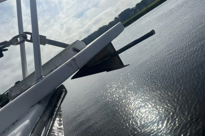 Slide: The Image of Anchor of 1983 Custom Key West 39' Sportfish boat over calm water. - 41