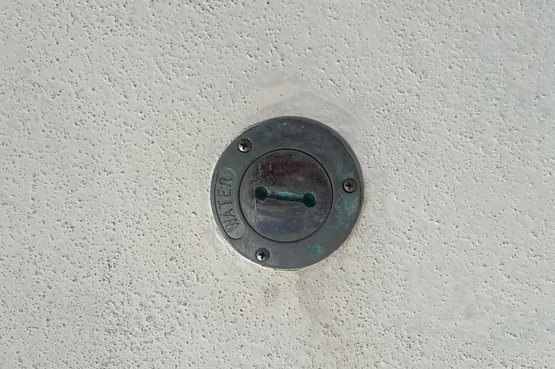 Slide: The Image of Water fill cap on 1983 Custom Key West 39' Sportfish boat. - 42