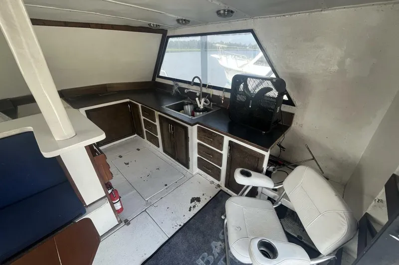 Slide: The Image of Interior of 1983 Custom Key West 39' Sportfish boat with seating and kitchenette. - 7