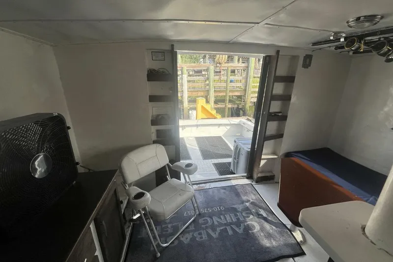 Slide: The Image of Interior of 1983 Custom Key West 39' Sportfish boat with seating and fishing gear. - 9